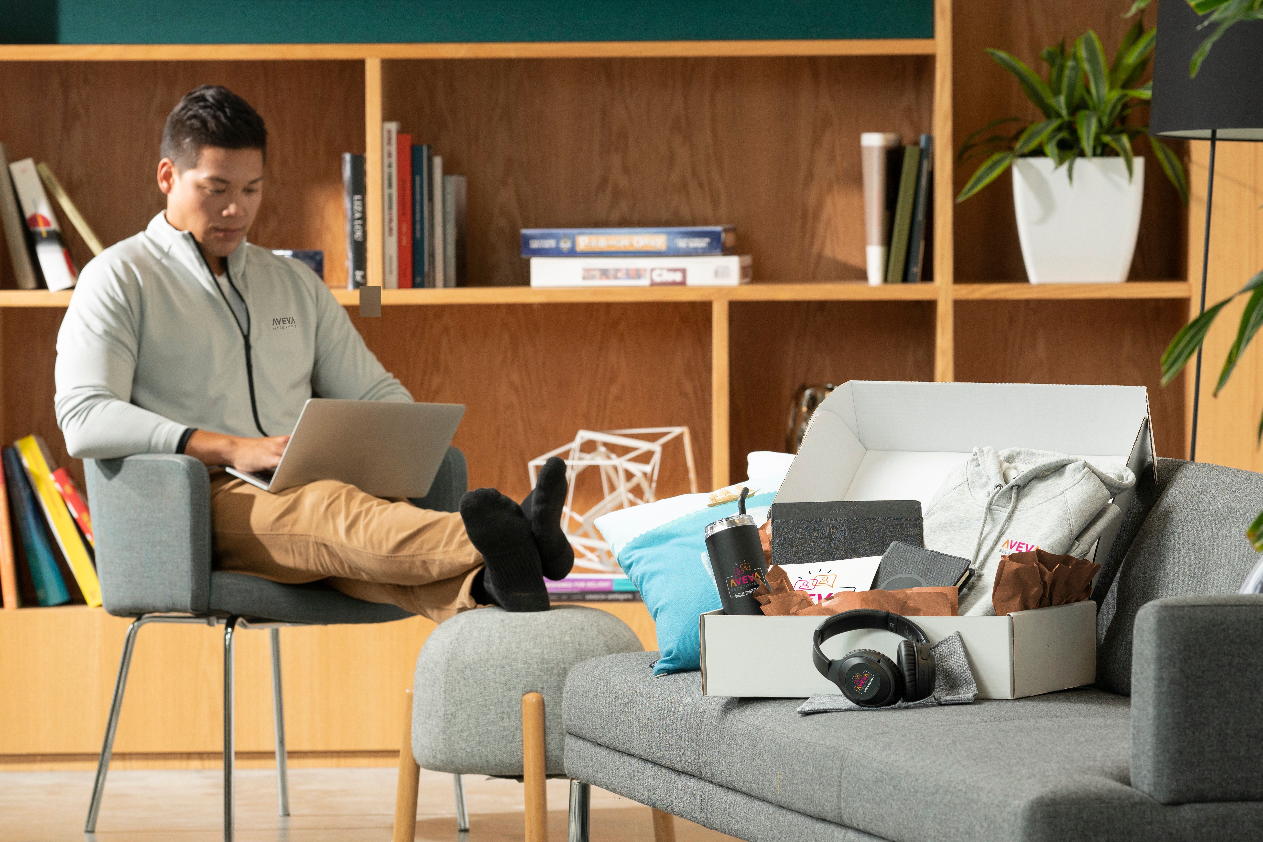 An image of a custom swag box with a bunch of products shown on a couch.