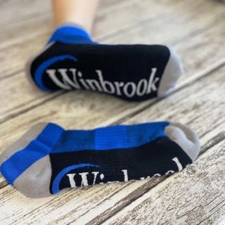 An image of an all over print sock with the logo printed on the bottom of the sock!