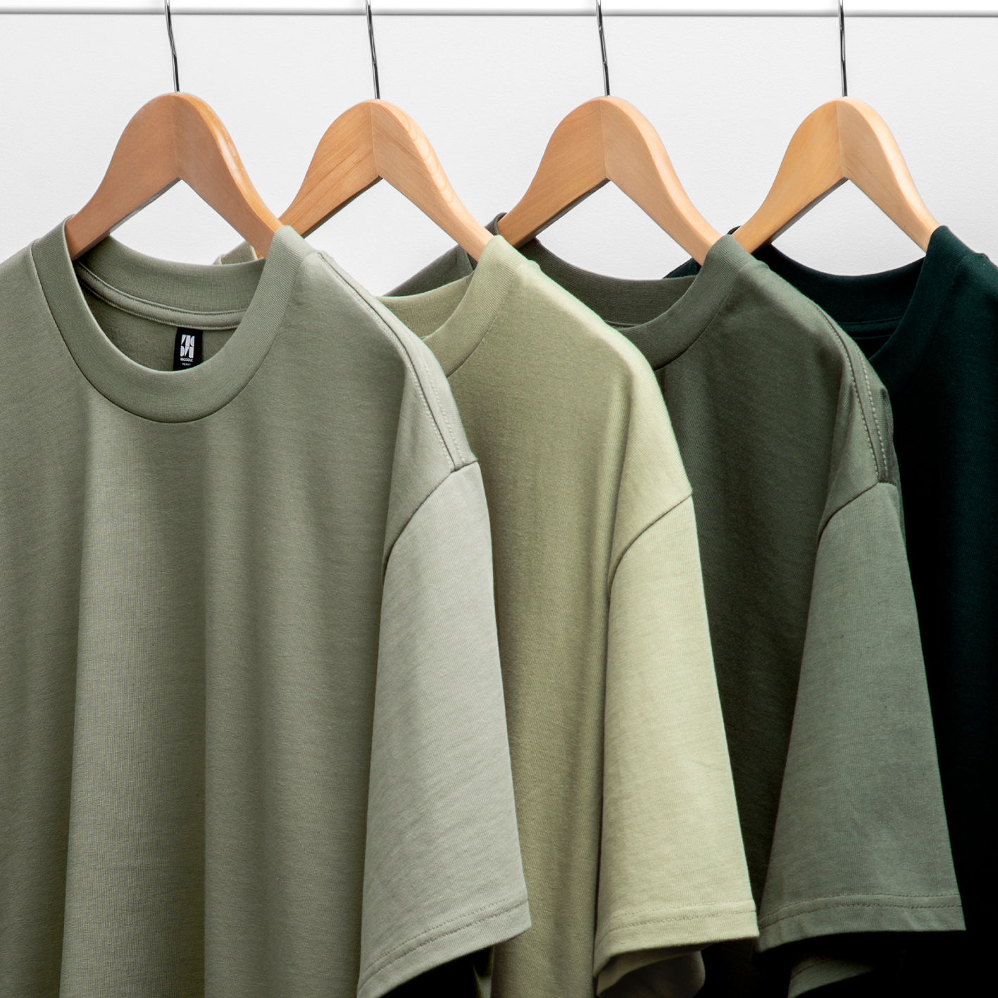 A variety of short sleeve t-shirts hung up on a rack.