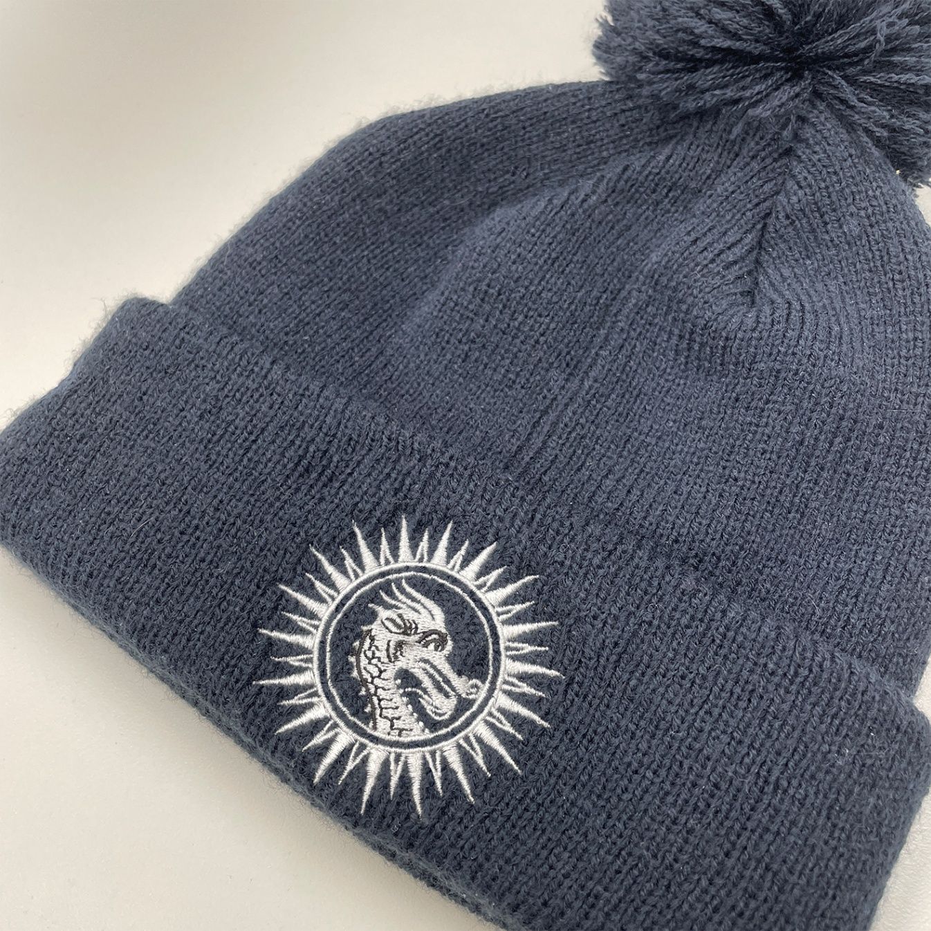 A close-up image of a custom embroidered toque.