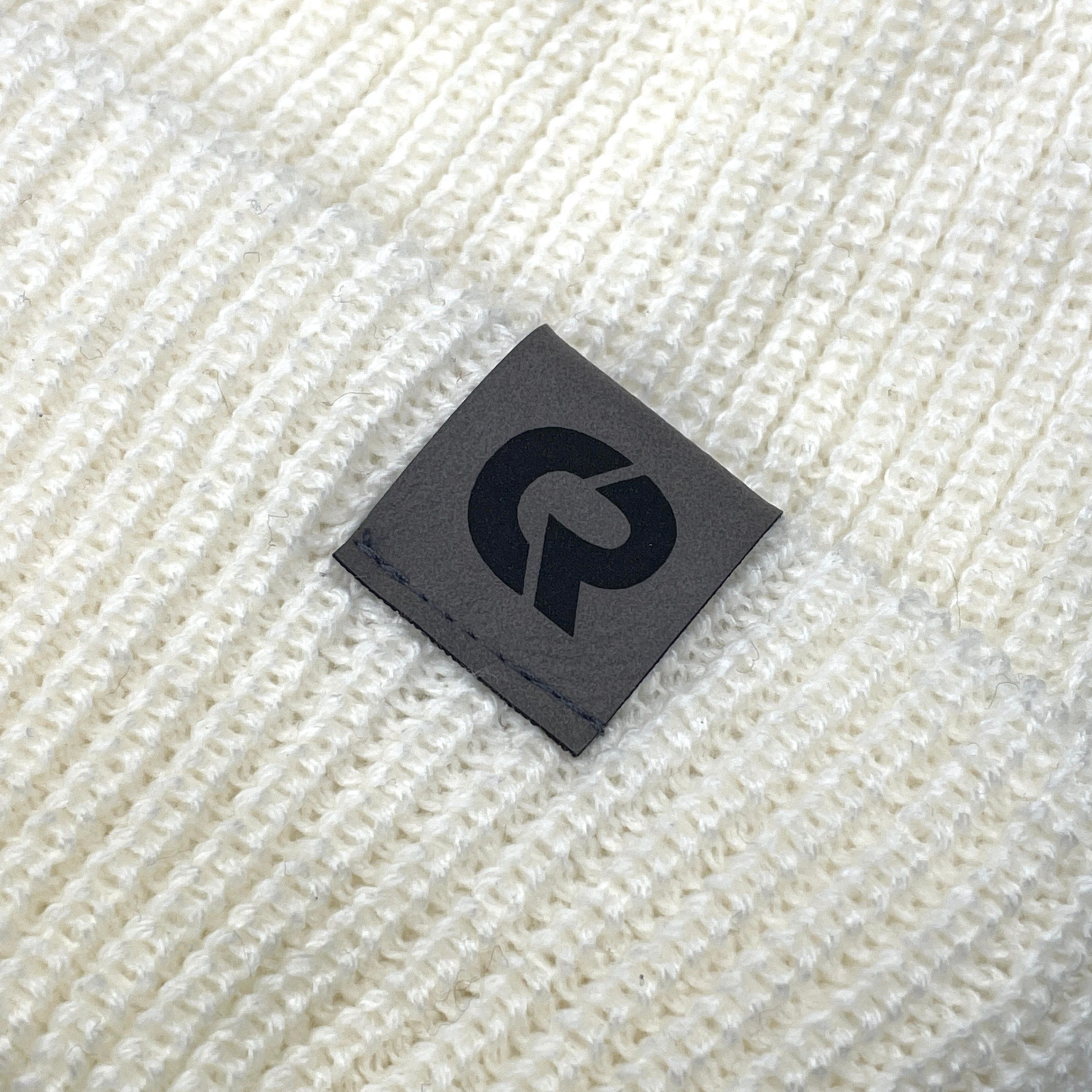 A close-up image of a custom leather label we printed.