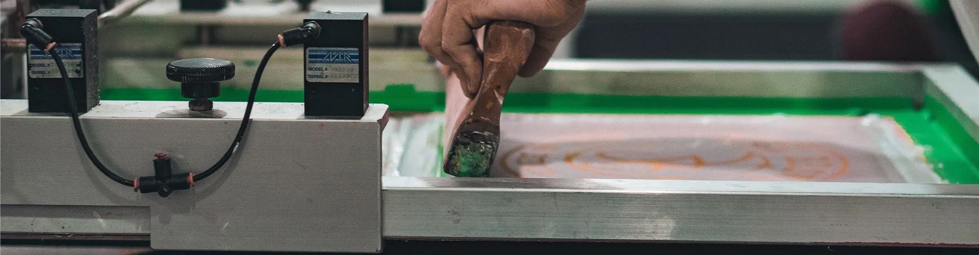 An image of someone manually screen printing.