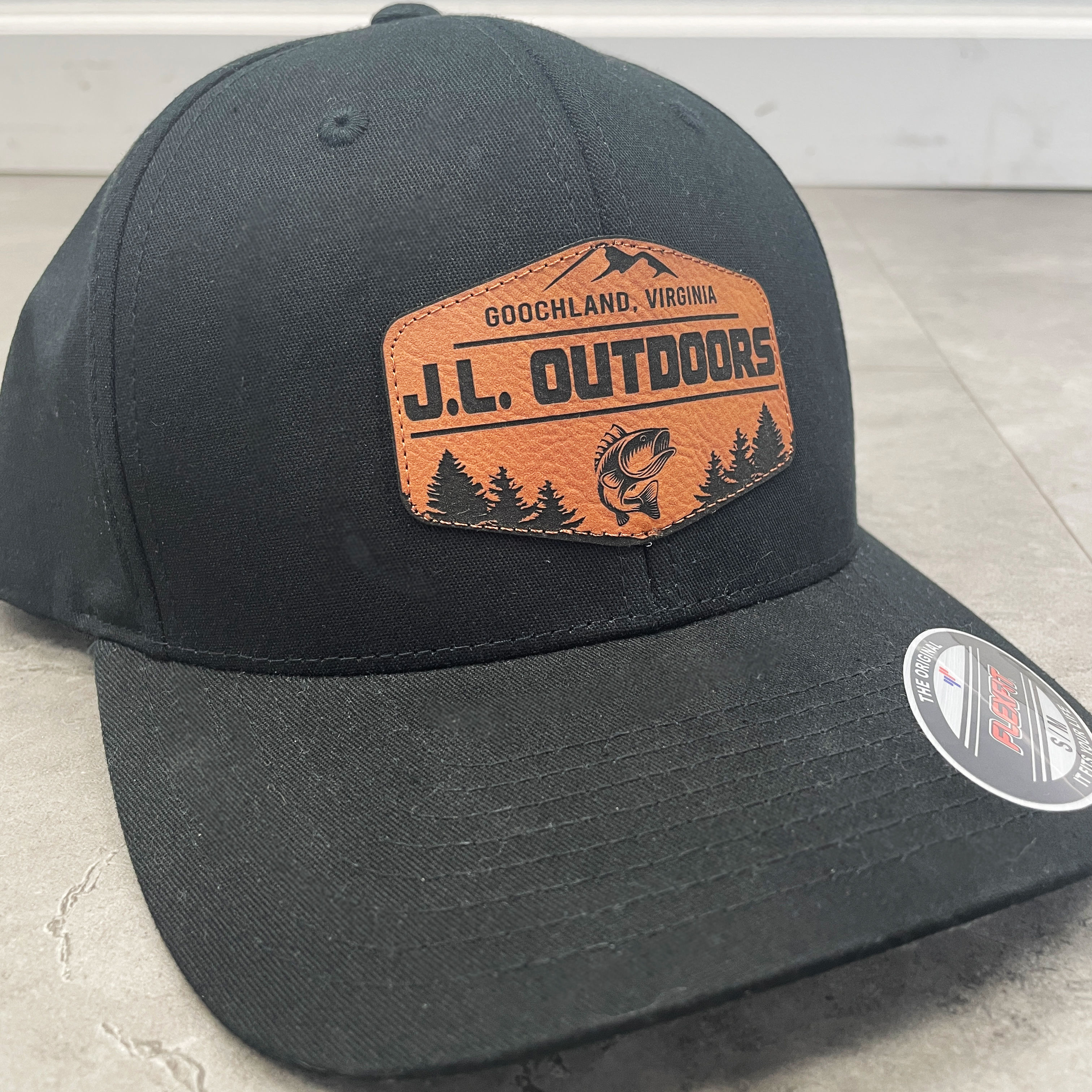 Leather patches on hats with printed custom designs.