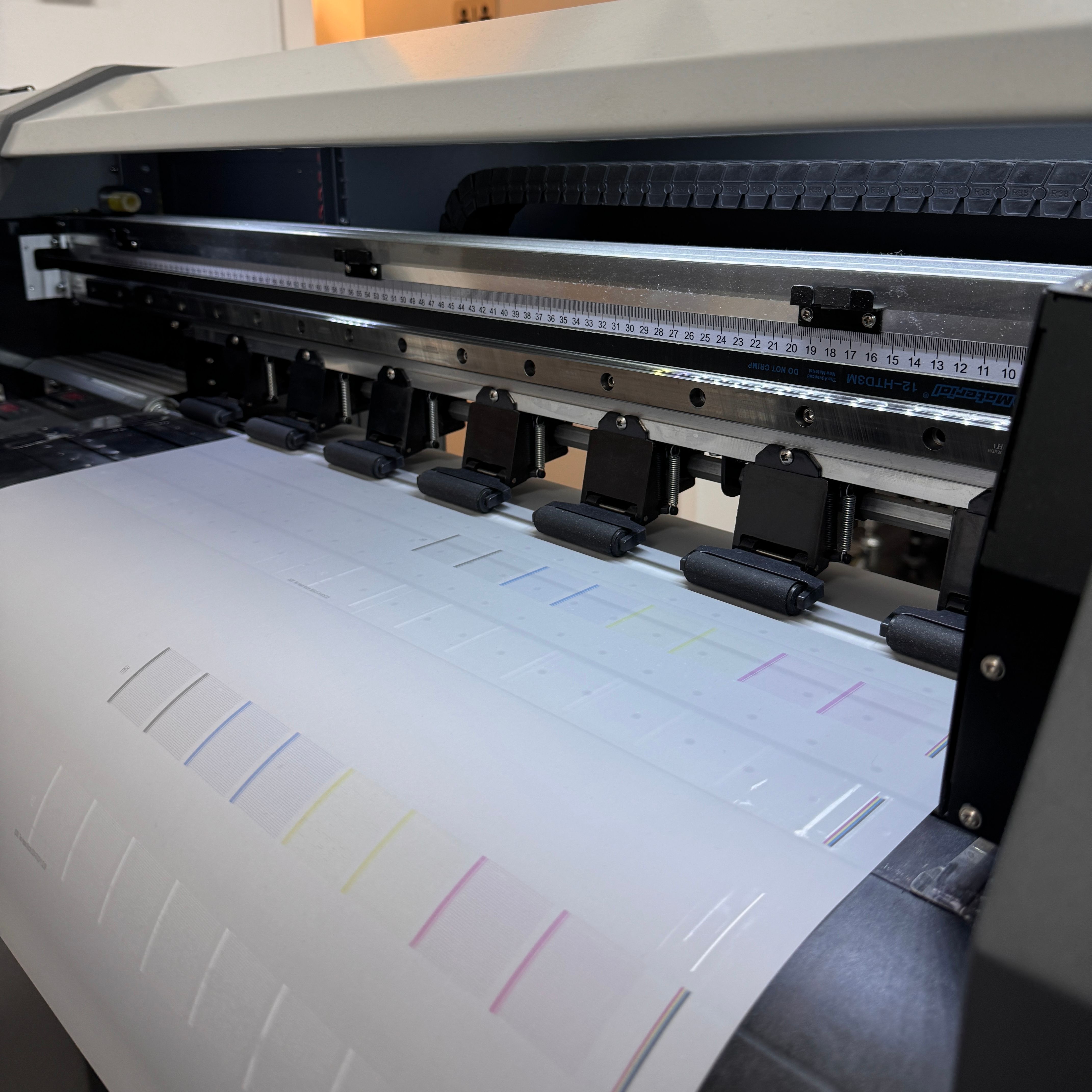 An image of the direct film transfer printing process where designs are printed on a film.