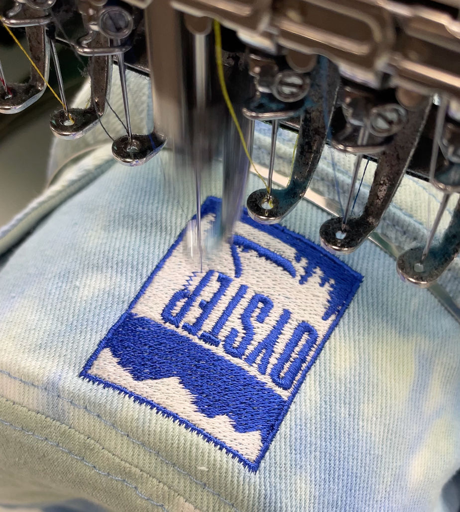 a bucket hat being embroidered with a logo
