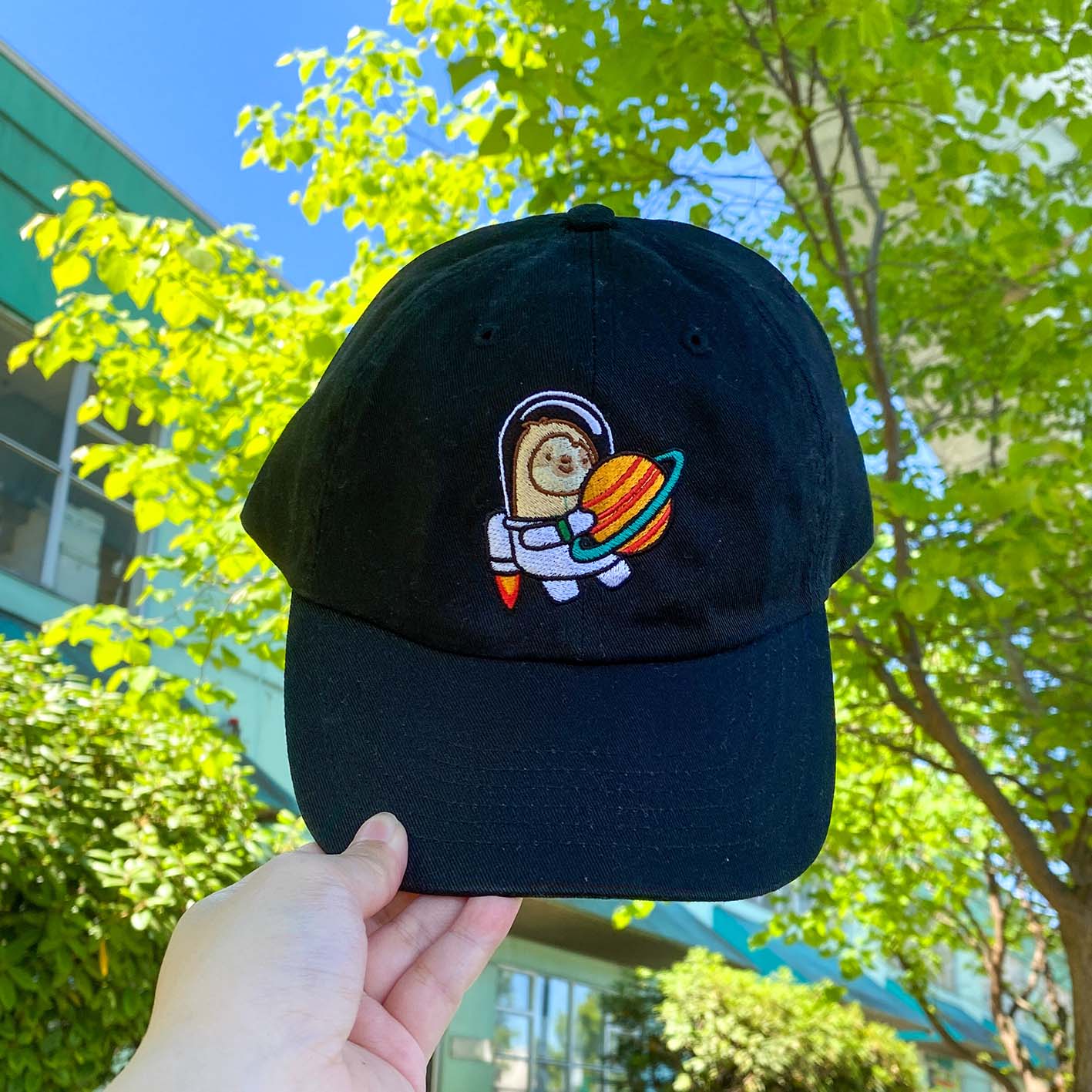 Custom dad hat with a relaxed fit, featuring vibrant, multicolored embroidery on the front panel. A stylish and playful design perfect for casual wear.