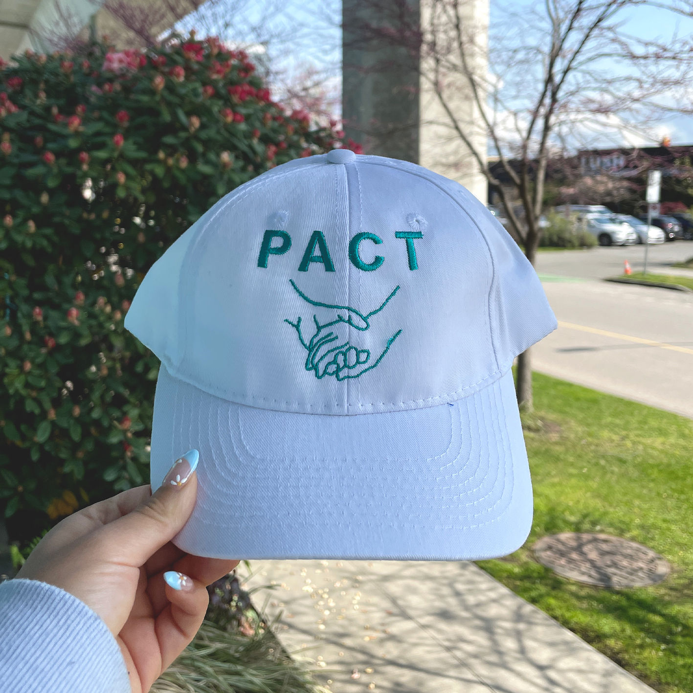 White hat embroidered with a design.