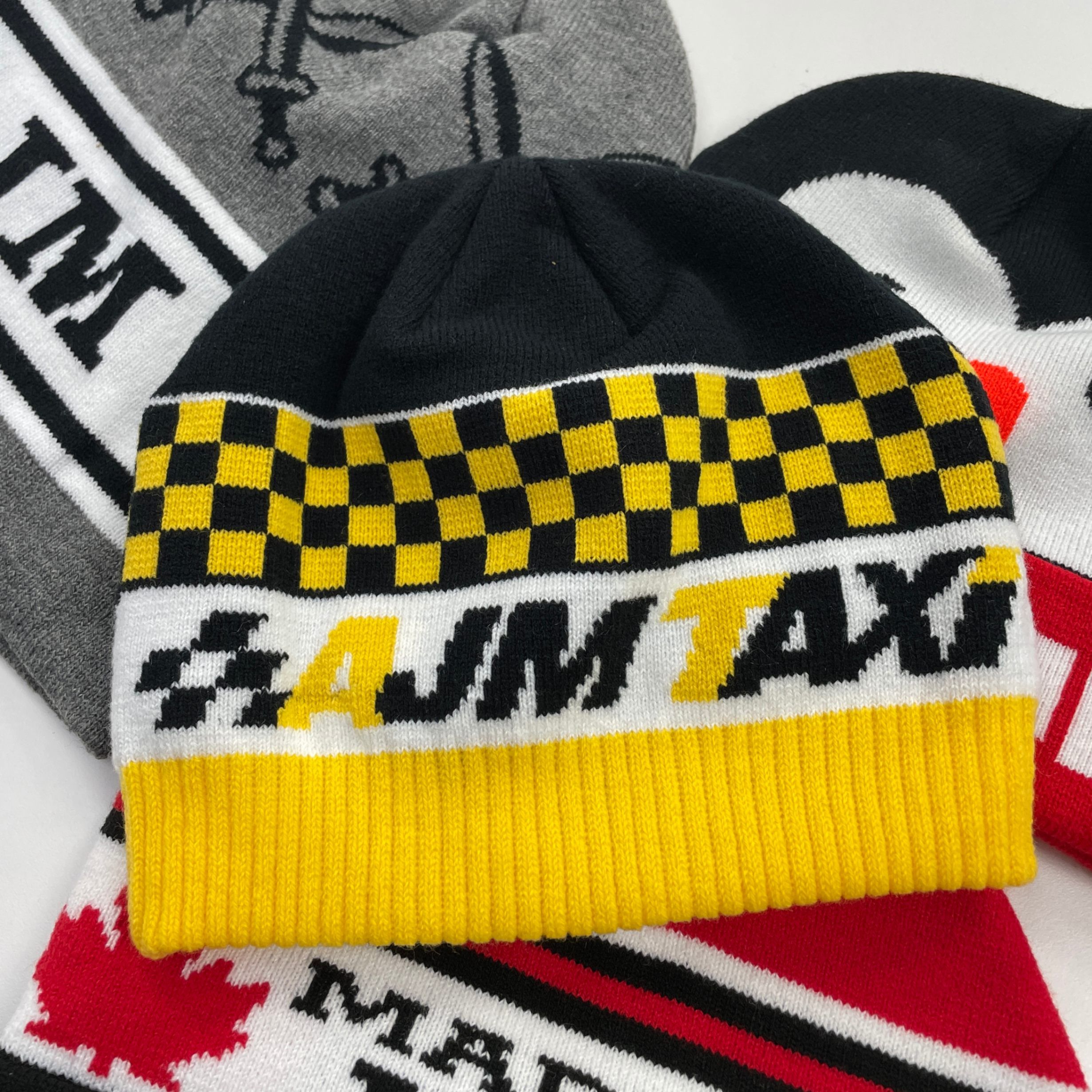 An image of an all over print toque with a yellow and white design