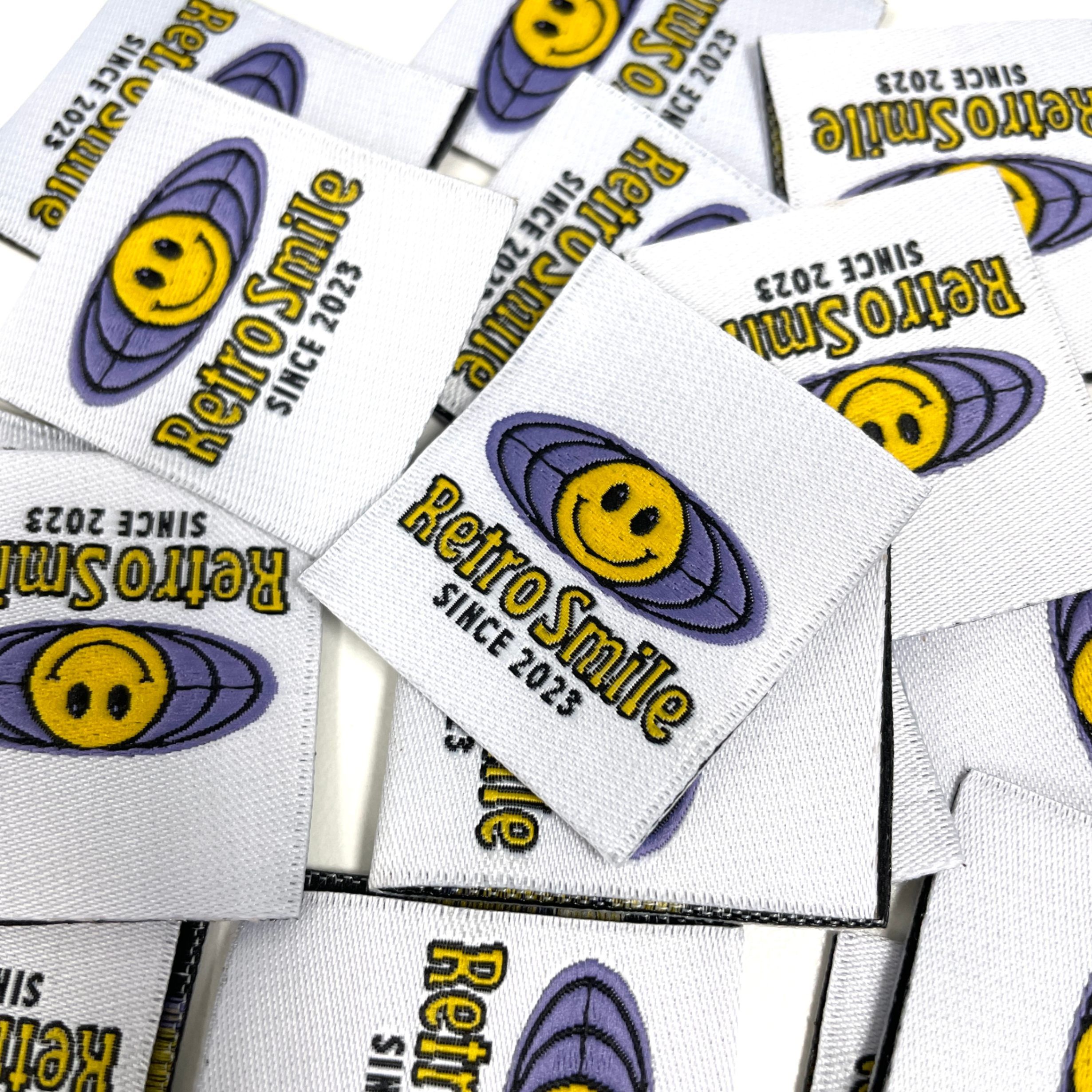 An image of custom woven labels with a colorful design printed.