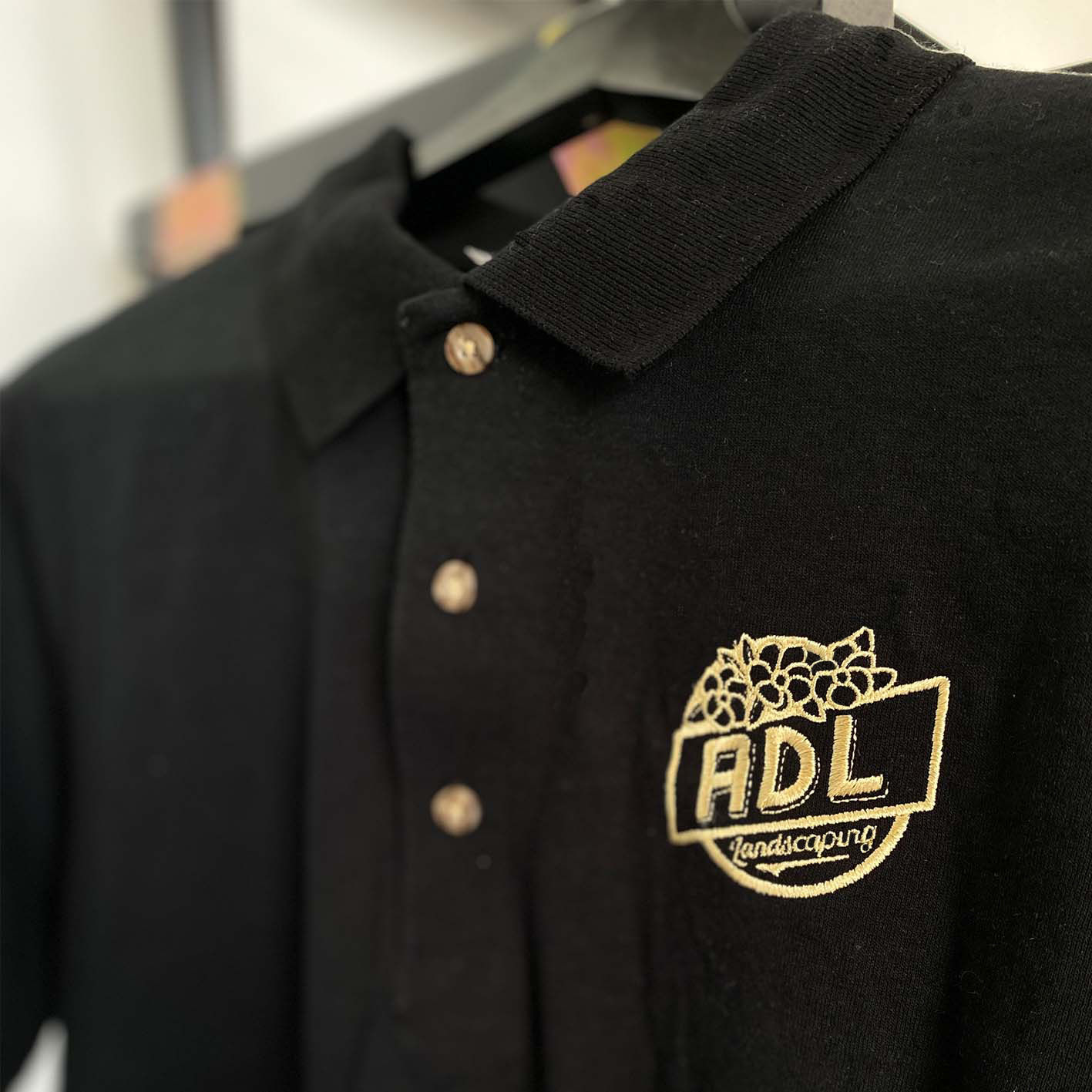 An embroidered design on a custom polo shirt.