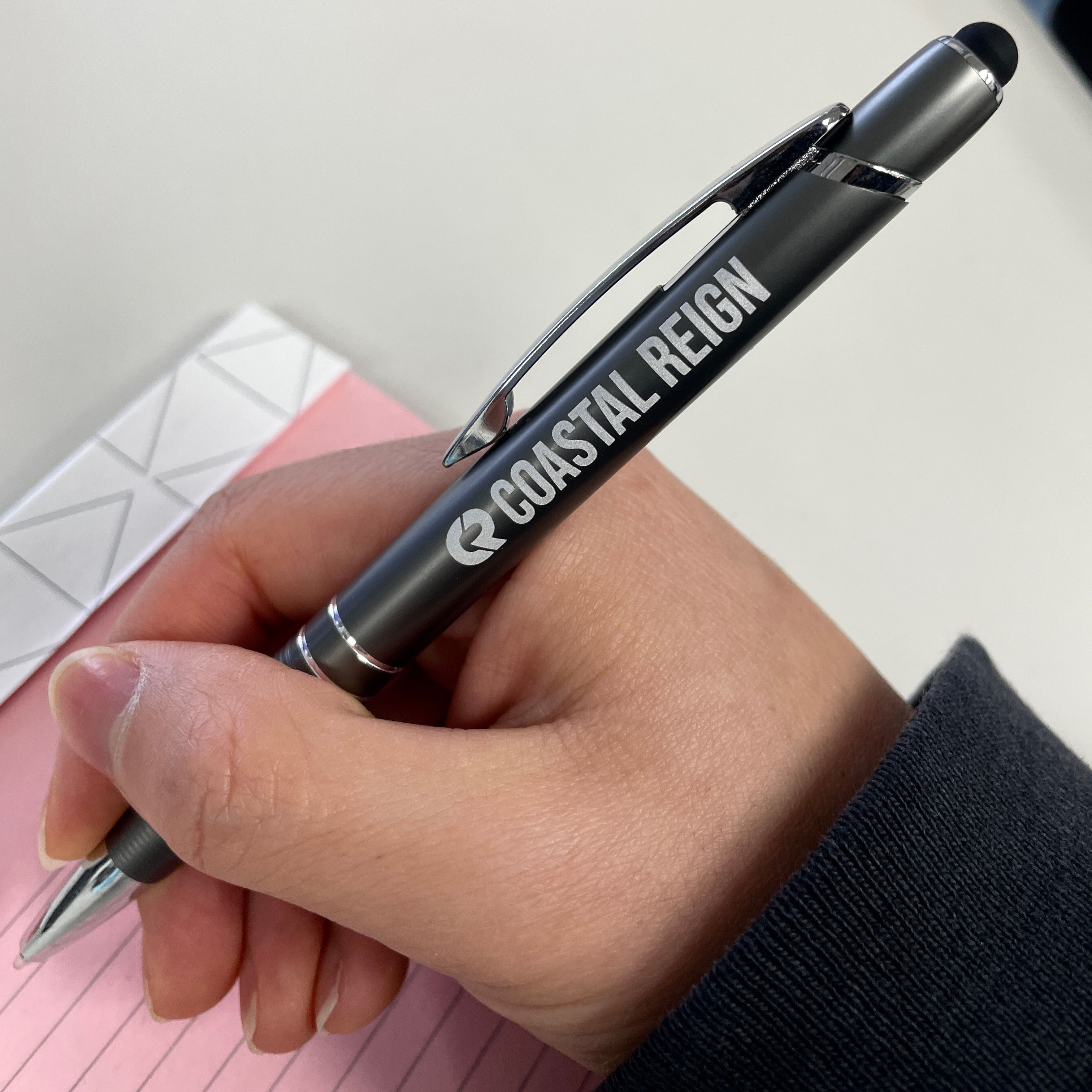 An image of a custom pen that was screen printed with our Coastal Reign logo.