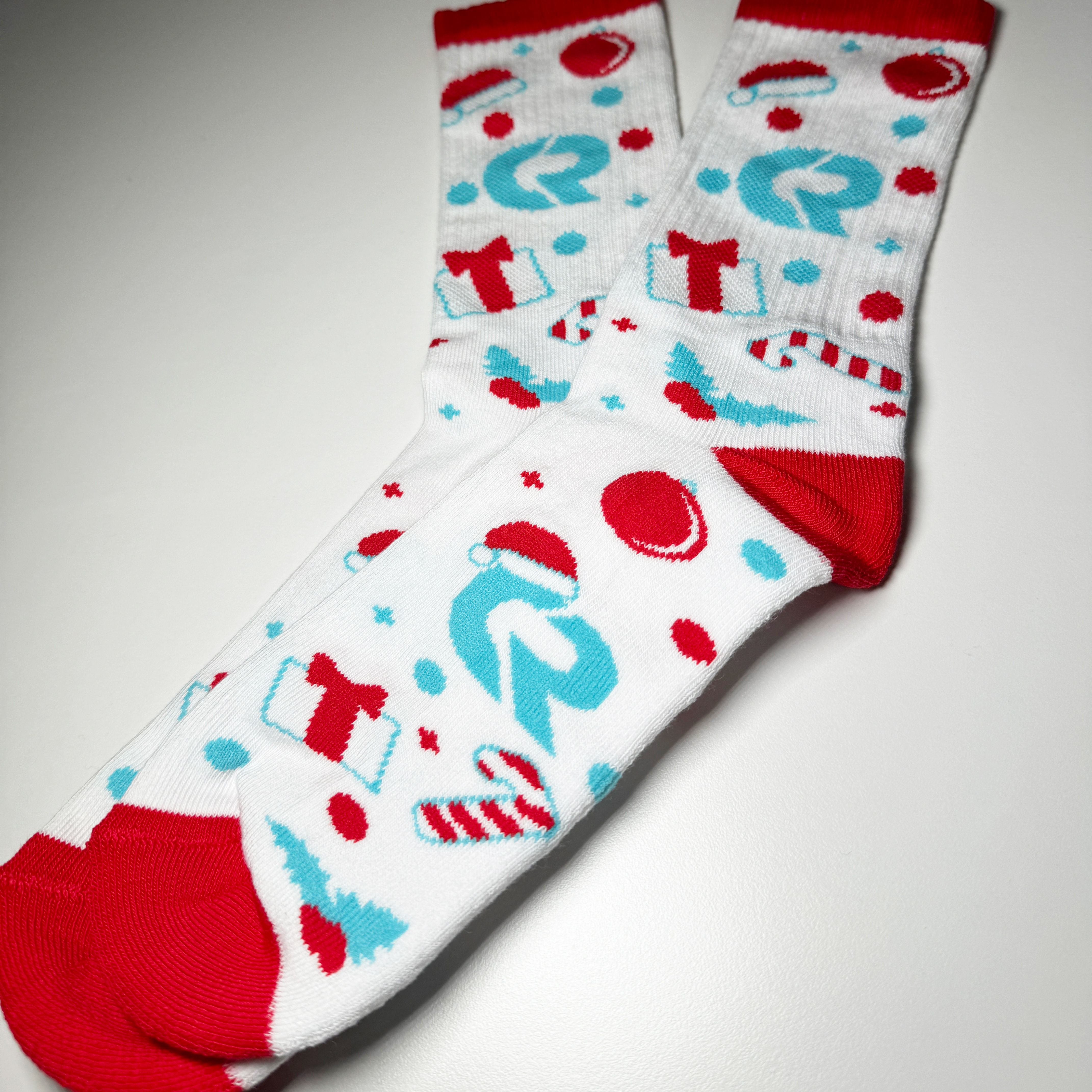 An image of custom all over print socks we printed with our Coastal Reign logo on it!