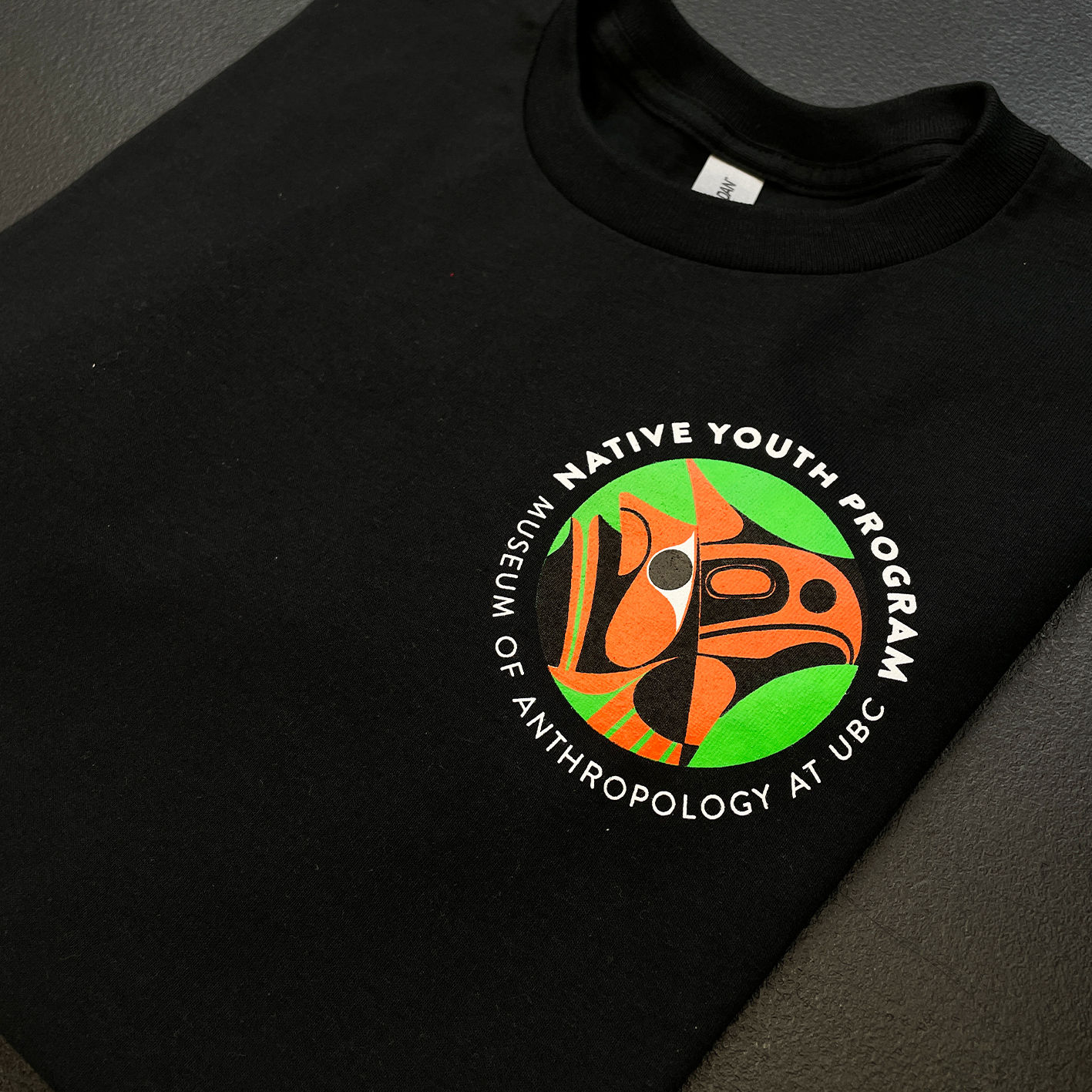A colorful screen printed design on the left chest of a t-shirt