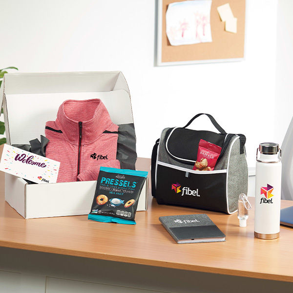 Welcome gift swag boxes for new employees, branded with the company's logo.