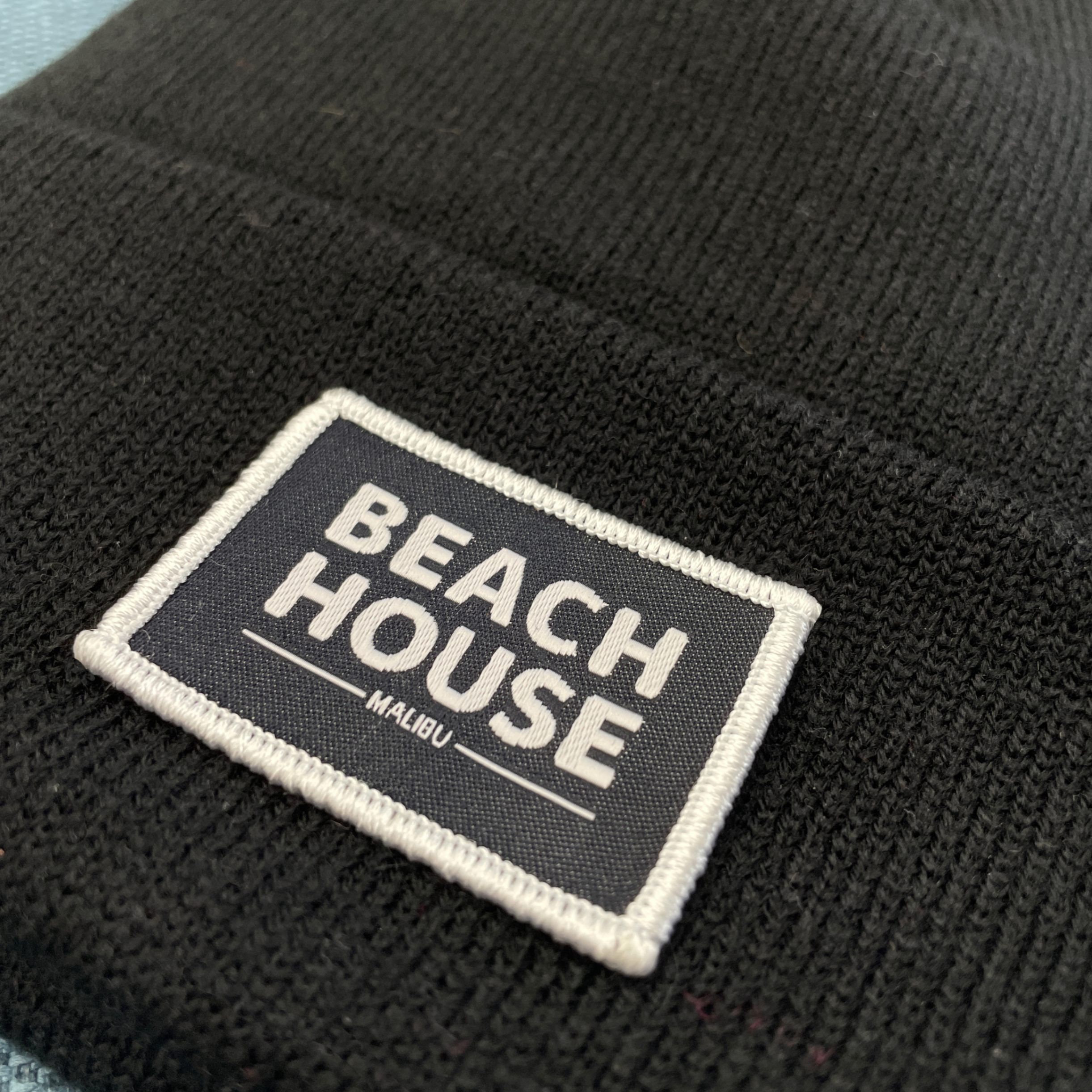 A close up of a custom woven patch toque that we printed for a customer.
