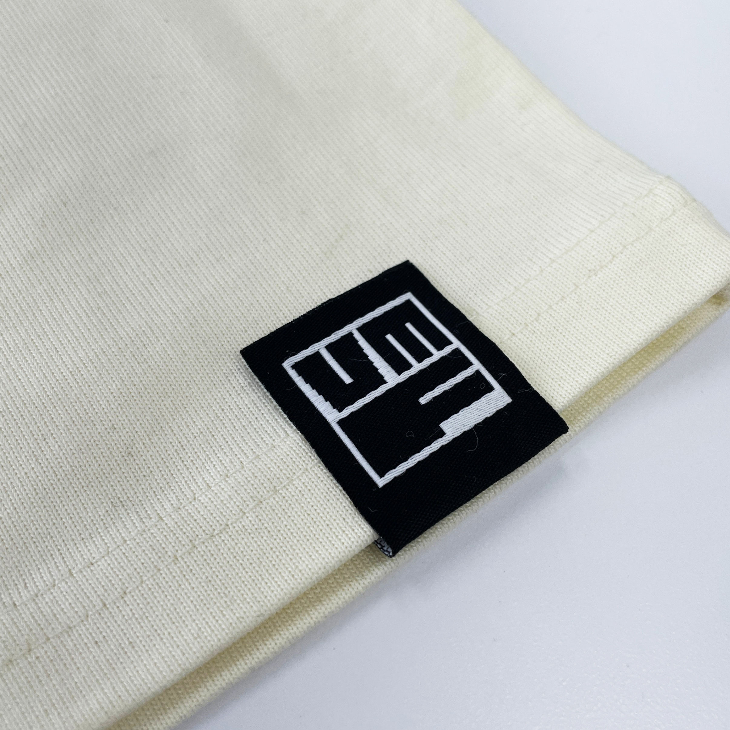 An image of a custom woven label we printed for Vancouver Mural Festival.