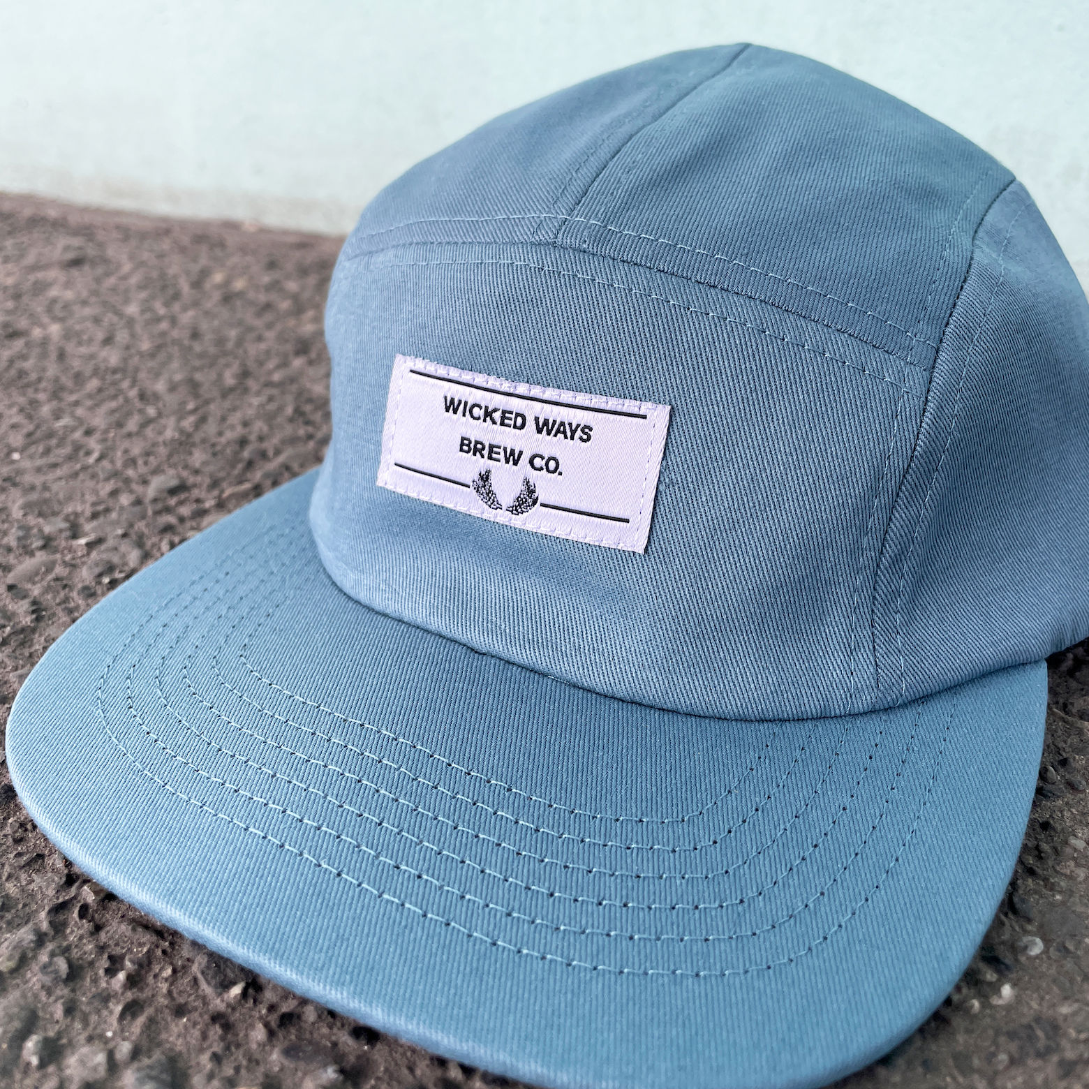 An image of a woven label attached to a hat.