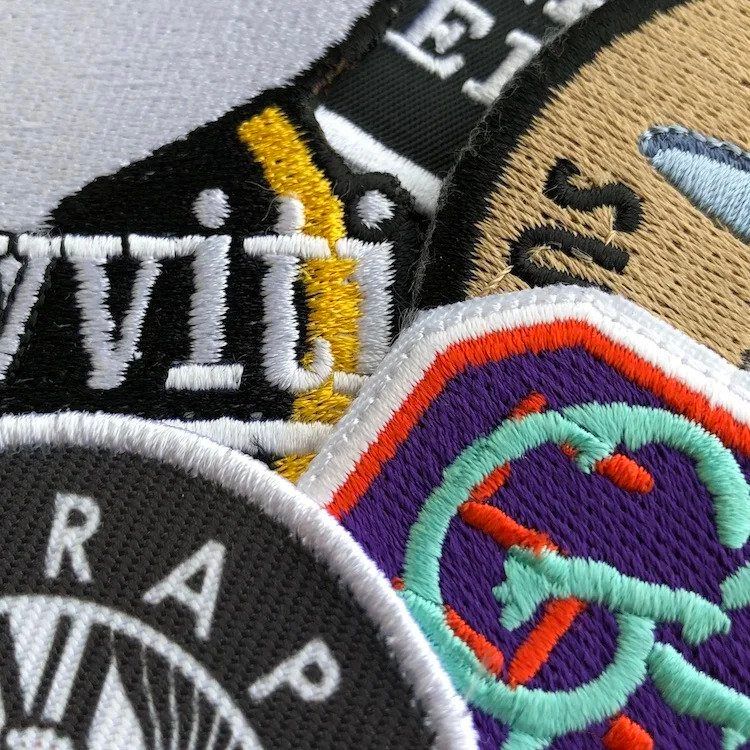 An image of some embroidered patches and sublimated patches we printed.