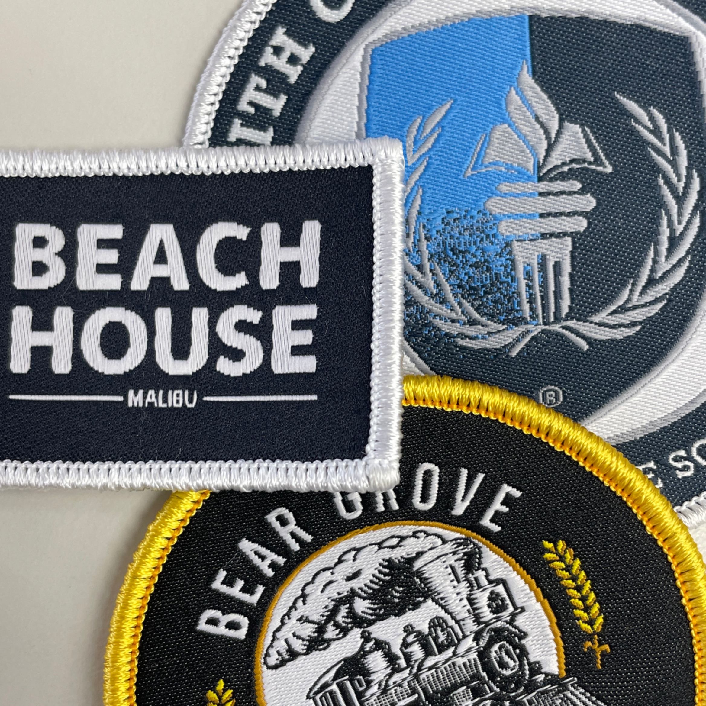 A collection of custom woven patches we have made for our clients.