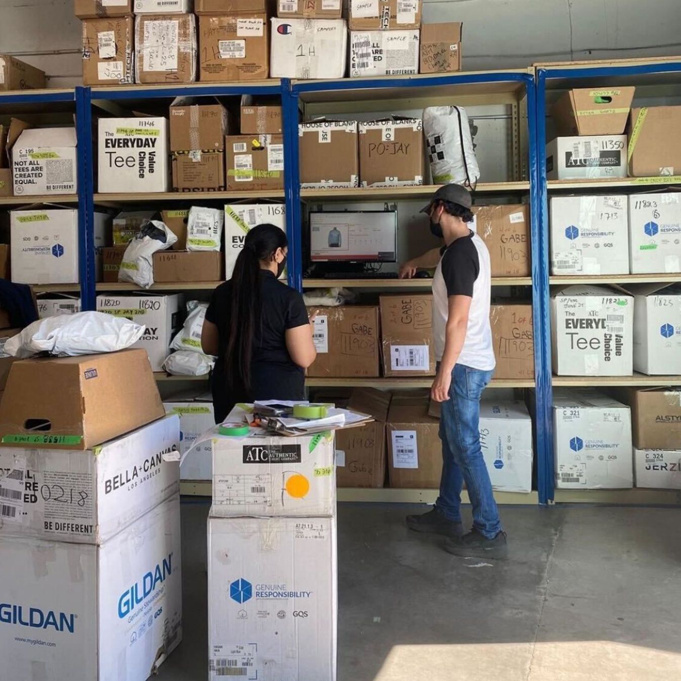 An image of Coastal Reign staff working in the warehouse